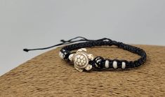 Sea Turtle Braided Macrame Bracelet. Black Bracelet with Turtle in Beige Sand Color. Handmade with  Black cord, White Beads and Turtle Bead. Adjustable Unisex Bracelet Handmade Beach Bracelet Adjustable Cord - Fits Most Size FAST SHIPPING! Visit my Etsy Shop to see more Designs Inspired in Turtles! Handmade Turtle Bracelets, Turtle Necklaces and Turtle Earrings. To visit my Etsy Shop Click here: https://www.etsy.com/shop/FreedomLifeStyle Handmade Black Wristband For Beach, Handmade Black Wristband For The Beach, Handmade Adjustable Turtle Bracelet, Black Bracelet For The Beach, Black Wristband Bracelet For The Beach, Turtle Necklaces, Braided Macrame, Hawaiian Bracelets, Beach Bracelet