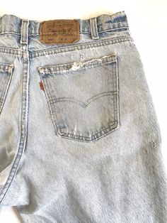 "Waist:34\" Rise:12.5\" Hips:44\" Inseam:30.5\" These 550's are USA made and super shredded with repairs, rips and some stains and discoloration. They're the epitome of Levis grunge jeans from the 90's with the ultra high rise, zip fly and light wash with tapered leg. Please refer closely to the photos for the stains, repairs and rips. They're tagged a vintage 36\" but bets fit a modern 34\". Measurements are provided above for an accurate fit. 🍑(2)" Grunge Style Light Wash High Rise Jeans, Grunge Light Wash High Rise Jeans, Vintage Faded Jeans With Frayed Hem, 90s Style Distressed Faded Jeans, Grunge High Rise Light Wash Jeans, Light Wash High Waist Grunge Jeans, Vintage Distressed Jeans For Spring, High Waist Light Wash Grunge Jeans, Vintage Jeans With Frayed Hem