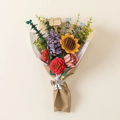 a bouquet of flowers is wrapped in brown paper