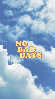 the words no bad days are written in orange and yellow on a blue sky with white clouds