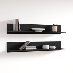 two black shelves with books and vases on them