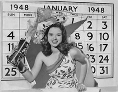 an old photo of a woman in front of a calendar