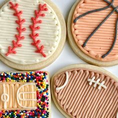 four decorated cookies with sports designs on them