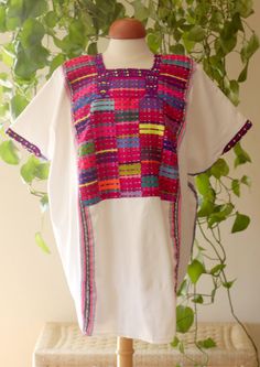 This exquisite tunic, also known as a Huipil, the traditional garment worn by Maya women, was made in the village of San Juan Cancuc in Chiapas. This huipil was hand woven from 100% cotton and embroidered using a traditional technique from the region. Textiles of this quality are rare finds, and are never duplicated so you will never find another one just like this. This garment measures 78cm long by 88cm wide, it is intended to have a loose, open fit. Traditional Cotton Kaftan With Woven Motifs, Traditional Multicolor Festive Tunic, Folk Style Cotton Kaftan With Woven Motifs, White Traditional Tops With Traditional Patterns, Traditional White Cotton Tunic, Folk Style Cotton Kaftan With Traditional Patterns, Traditional Cotton Kaftan With Embroidered Border, Traditional Multicolor Tunic For Festivals, Traditional Multicolor Tunic Tops