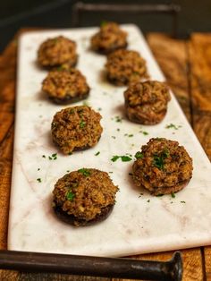 some meat patties are on a white plate and ready to be cooked in the oven