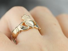 This traditional Claddagh ring has excellent details and clear, clean lines. Betrothal rings depicting two clasped hands date back many centuries in European history. The Irish version, the Claddagh ring, came about in the 1600s and has been produced continually since that time. Traditionally the hands represent friendship, the heart is for love, the crown is for loyalty. These three elements combined create the Claddagh, which is as much a symbol of Ireland as it is of love. These classic rings Classic Brass Jewelry For Promise Ring, Symbolic Intricate Design Jewelry For Anniversary, Classic Ceremonial Brass Jewelry, Hand Cast Antique Rings For Anniversary, Antique Hand Cast Rings For Anniversary, Antique Hand Cast Wedding Jewelry, Antique Hand Cast Jewelry For Wedding, Antique Adjustable Yellow Gold Jewelry, Antique 14k Gold Jewelry For Promise Ring