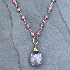 Gemstone necklace with shimmering pink tourmaline and a light purple amethyst pendant,  hand-wrapped rosary style on 14k gold filled wire. All metals used are 14k gold filled,  made to last for years to come.  Length: necklace is finished with a 14k gold-filled lobster clasp and extender chain, making it adjustable in length from 17 to 19 inches. Packaging: All orders are lovingly packaged in a gift box, wrapped with a ribbon. Please visit my Etsy shop for a full selection of my handmade jewelry Purple Rose Quartz Gemstone Jewelry, Pink Amethyst Jewelry With Gemstone Accents, Pink Amethyst Gemstone Jewelry, Purple Pink Sapphire Jewelry For Gift, Pink Sapphire Purple Jewelry As Gift, Handmade Purple Rose Quartz Jewelry, Pink Amethyst Gemstone Beads Jewelry, Pink Amethyst Jewelry With Gemstone Beads, Pink Amethyst Wire Wrapped Jewelry