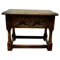 an old wooden table with carvings on the top and bottom shelf, isolated against a white background