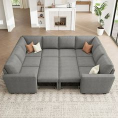 a large gray sectional couch sitting on top of a living room floor