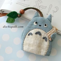 a small bag with a totoro design on it