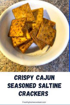 crispy cajun seasoned saltine crackers in a white bowl on a granite countertop