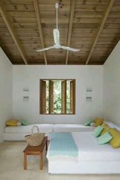 a bedroom with two beds and a ceiling fan