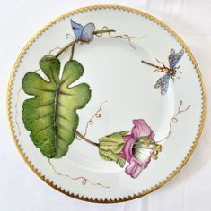 a plate with flowers and butterflies painted on it