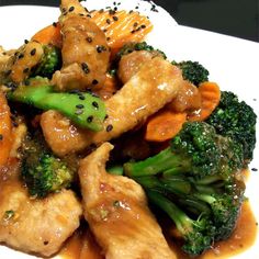 chicken and broccoli stir fry on a white plate