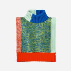 an orange, blue and green sweater with a turtle neck on top of white background