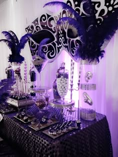 a table topped with lots of purple and black decorations