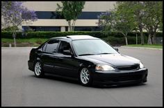 a black car parked in front of a building