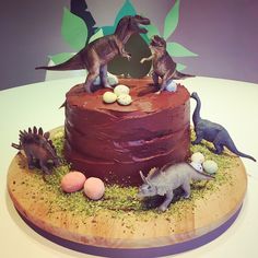 a cake decorated with dinosaurs and eggs