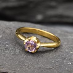 Dainty Amethyst Gold Ring set with Natural Amethyst in a diamond cut, flawless clarity & purple color, at size 5mm (0.6 Ct) from Brazil. Gold Vermeil: 18k Gold over Solid 925 Sterling Silver ☞ made to last. Click here for ☞ Matching PendantMatching Earrings ☞ please ask meClick here for ☞ Amethyst - February CollectionDetails:• Natural Amethyst sourced from Brazil• Amethyst: 5mm each, 0.6 Ct total, diamond cut• Dimensions: Band width ≈ 2.3mm, thickness ≈ 1.2mm• 18k Gold Vermeil❀ Each Natural Gem Gold Amethyst Ring, Purple Rings, Promise Ring Gift, Amethyst Gold, Gold Ring Sets, Bar Pendant, Proposal Ring, Amethyst Ring, Diamond Cut