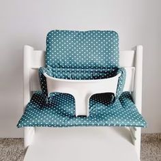 a white and blue chair with polka dots on it