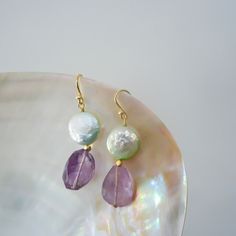 PRODUCT DETAILS: * Earrings made Gemstone * Materials:         +Pearl TFL-12x12 mm      +Amethyst 12x17 mm * Size: 4,5cm * Metal Parts: Silver14K Gold Plated Dainty  * Made in Quang Nam - Viet Nam (handmade) CAUTIONS: Product color in hand may vary from pictures due to the light disparency but the quality is not changed. CUSTOMER SERVICES: We prioritize a fast shipping method Products in hand around 10-18 days Do not hesitate to contact me if you have any dissatisfaction with our services CUSTOM Gemstone Teardrop Dangle Earrings For Wedding, Gemstone Dangle Teardrop Earrings For Wedding, Dangle Teardrop Gemstone Earrings For Wedding, Wedding Gemstone Teardrop Dangle Earrings, Wedding Dangle Teardrop Gemstone Earrings, Elegant Round Beaded Earrings With Natural Stones, Bohemian Round Pearl Earrings For Wedding, Handmade Amethyst Earrings For Wedding, Bohemian Pearl Wedding Earrings With Ear Wire