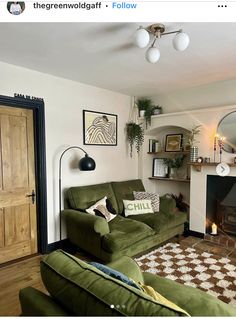 a living room filled with furniture and a fire place in front of a mirror on the wall