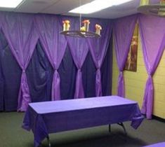 two tables with purple cloth draped over them