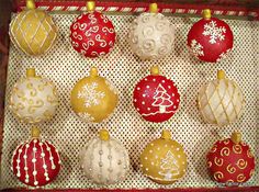 a box filled with christmas ornaments on top of a white netted surface and red trimming