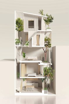 the interior of an apartment with white walls and floors, plants on each floor, and stairs leading up to the second floor