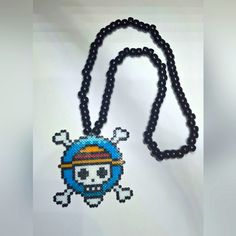 a beaded necklace with a skull and crossbones on it