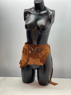 a female mannequin wearing a leather belt