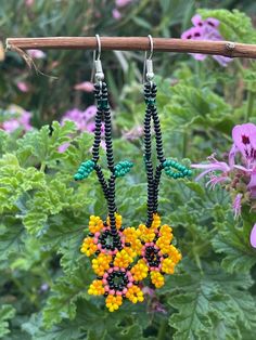 Beaded dangle earrings  Measurements do not include the earring wire hook:  7.5cm long 2cm wide Orange Beaded Flower Earrings, Orange Flower Earrings With Colorful Beads For Gift, Yellow Dangle Flower Earrings With Colorful Beads, Bohemian Orange Flower Beaded Earrings, Handmade Orange Dangle Flower Earrings, Yellow Beaded Flower Earrings, Yellow Flower Earrings With Colorful Beads, Yellow Flower Earrings With Round Beads, Yellow Flower-shaped Beaded Earrings