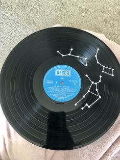 an old record with the word decal on it sitting on someone's lap