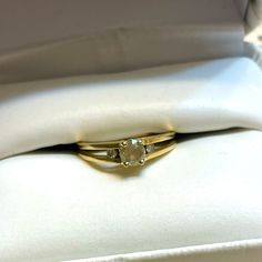 an engagement ring in a white box