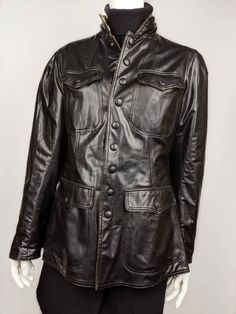 "Classic fitted WW2 style jacket from JEAN PAUL GAULTIER. Fully snaps down the middle to a high collar on neck. Two front pockets which also snap button closed. Hourglass fit with larger shoulders that make the waist even more defined. Size USA 10/M (See the measurements) Condition 8/10 (Slightly rubbed 3 buttons on the pockets, there are 2 cracks at the bottom) Made in ITALY Underarm to underarm - 42cm/16,5\" Length from the back - 66cm/26\" Sleeve length from seam - 63cm/24,8\" Sleeve length f Classic Workwear Biker Jacket With Flap Pockets, Classic Fitted Brown Utility Jacket, Classic Biker Jacket With Flap Pockets For Work, Fitted Classic Brown Utility Jacket, Winter Biker Jacket With Stand Collar For Work, Classic Biker Jacket With Pockets For Work, Winter Classic Biker Jacket With Stand Collar, Classic Winter Biker Jacket With Stand Collar, Winter Military Leather Outerwear