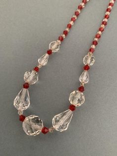 Andriani Vintage is pleased to offer for sale this wonderful example of a vintage glass beaded necklace. Great contrasting red and clear beads in colour and faceted.Has a nice weight with smaller beads as separators which is a nice original detail. 40cms around the neck Barrel claspLarge bead is 1cms diameter Some small surface scratches on the glass and small chips  but nothing that detracts from the originality and beauty of product.Great item at a great affordable price.Pleas check out my oth Vintage Round Beaded Crystal Necklaces, Vintage Beaded Round Crystal Necklaces, Vintage Beaded Crystal Necklaces, Vintage Single Strand Crystal Necklace With Round Beads, Vintage Crystal Necklace With Single Strand Round Beads, Vintage Clear Round Bead Necklaces, Red Glass Beaded Necklaces With Polished Beads, Vintage Crystal Necklace With Faceted Beads For Gift, Vintage Crystal Necklaces With Polished Beads For Gift