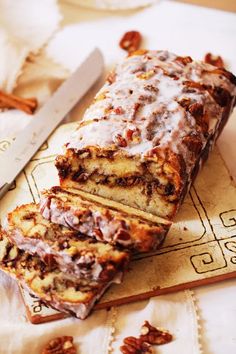 a loaf of pecan bread sitting on top of a table next to a knife