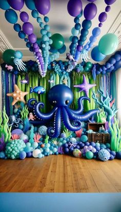 an under the sea themed birthday party with balloons, streamers and octopuses on the ceiling