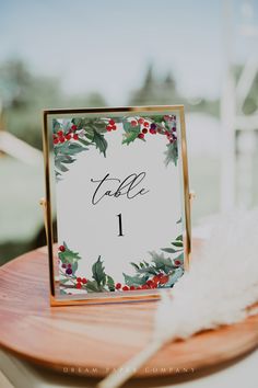 a table number with holly leaves and red berries