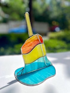 a colorful umbrella sitting on top of a white table