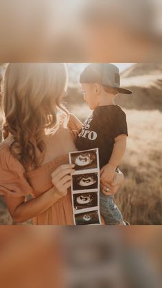 a woman holding a small child in her arms with the word love spelled on it