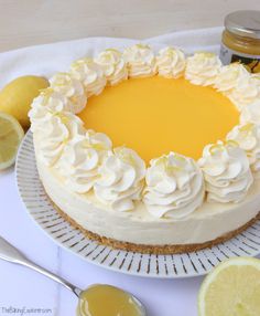 a cake with white frosting and lemons around it