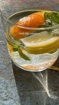 an orange and lemon drink in a glass on a table with the caption reads feels like summer