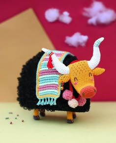 an animal made out of yarn sitting on top of a table