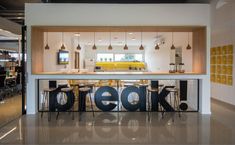 an open concept kitchen and dining area with the word geek spelled out on the counter