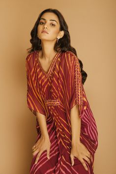 Wine kaftan with all-over chevron print and V-neck.
Component: 1
Printed, Embellished
Neckline: V-Neck
Sleeve Length: Three Quarter
Fabric: Georgette
Color: Maroon
Embellishments at the neckline, sleeves and waist
Note: Inner slip worn by the model is not for sale - Aza Fashions Kaftan Women, Kaftan For Women, Printed Kaftan, Embellished Neckline, Fashion App, Chevron Print, Not For Sale, Aza Fashion, Three Quarter