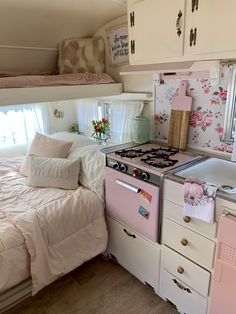 a pink stove top oven sitting inside of a kitchen next to a white counter top