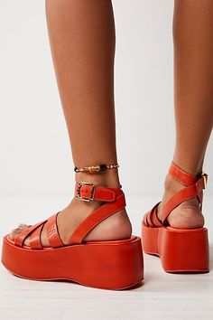 Simple and strappy, these platform sandals feature a lifted sole with a toe loop, criss-cross upper, and a buckle ankle strap. **Features:** Slip-on style, leather uppers, strappy design, toe loop, adjustable buckle ankle strap, flatform sole, lined footbed **Why We | Hazel Flatform Sandals by FP Collection at Free People in Orange, Size: US 8.5 Bold Ankle Strap Sandals For Spring, Bold Sandals With Heel Strap For Summer, Spring Toe Loop Sandals With Tang Buckle, Bold Sandals With Heel And Ankle Strap, Summer Toe Loop Sandals With Tang Buckle, Toe Loop Sandals With Tang Buckle For Summer, Bold Platform Wedge Heel Sandals, Leather Platform Strappy Sandals, Leather Strappy Platform Sandals