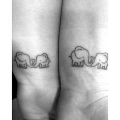 two small elephants on their legs with the word love written below them in cursive font