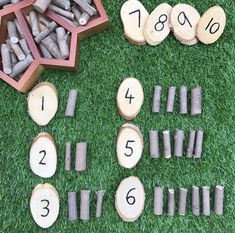 several pieces of wood are arranged on the grass next to each other with numbers in them